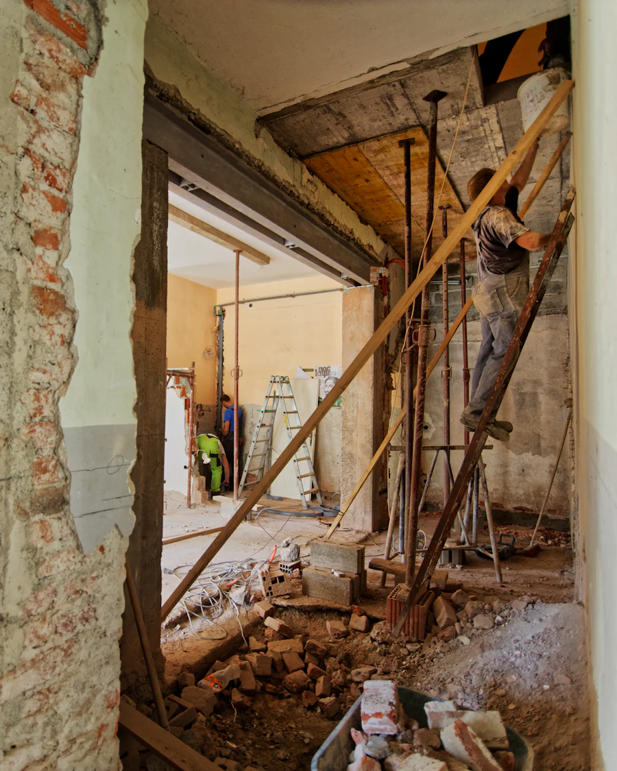 A builder working on a ladder inside a home
