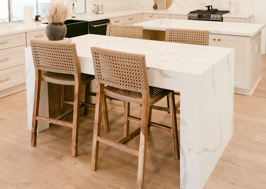 A bright kitchen with woven bar stools