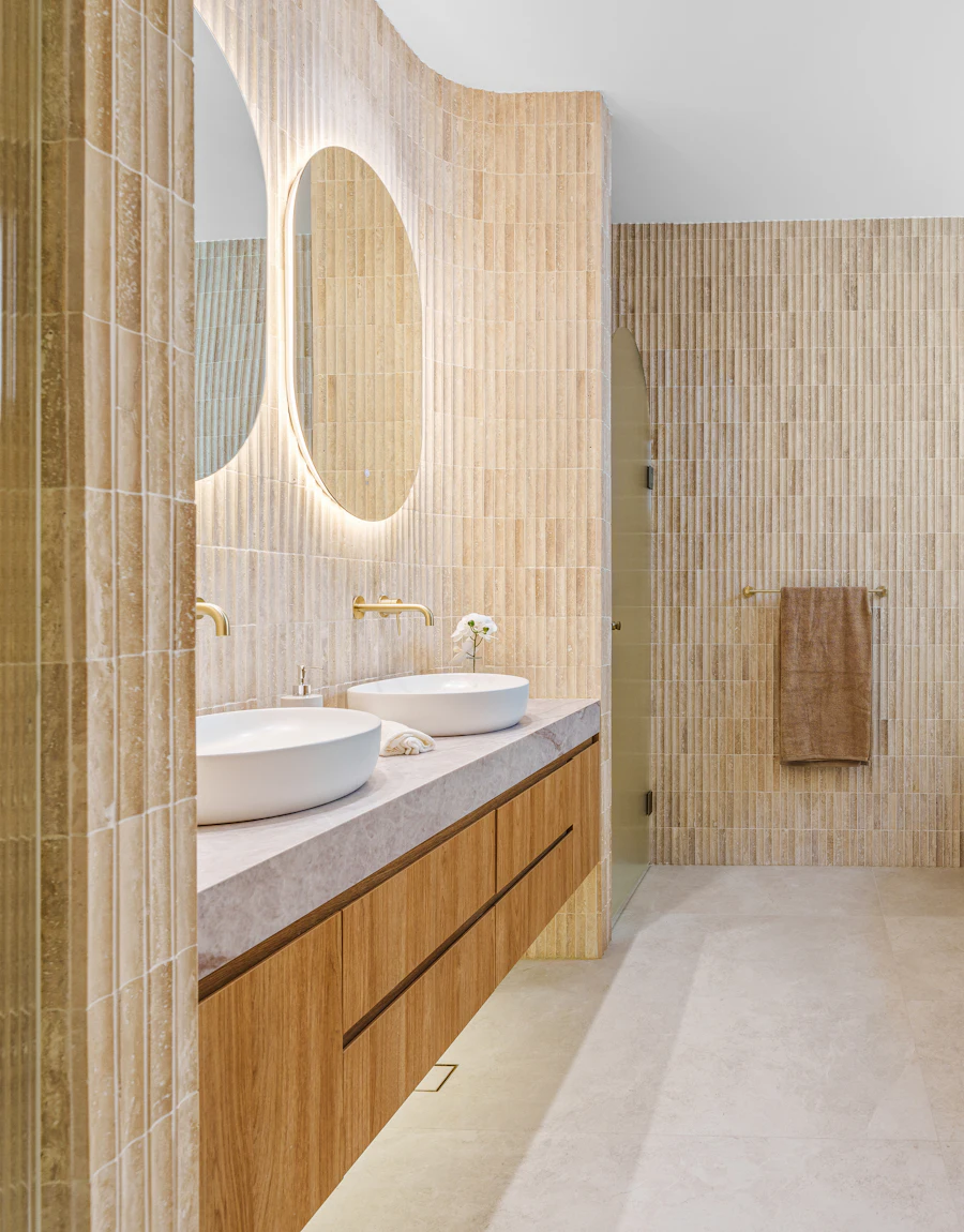 A bathroom with double sinks and a freestanding tub